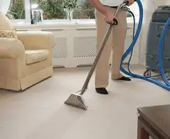 Carpet cleaning professional removing dirt and stains with a hot-water extraction tool in a home, Stamford, CT.